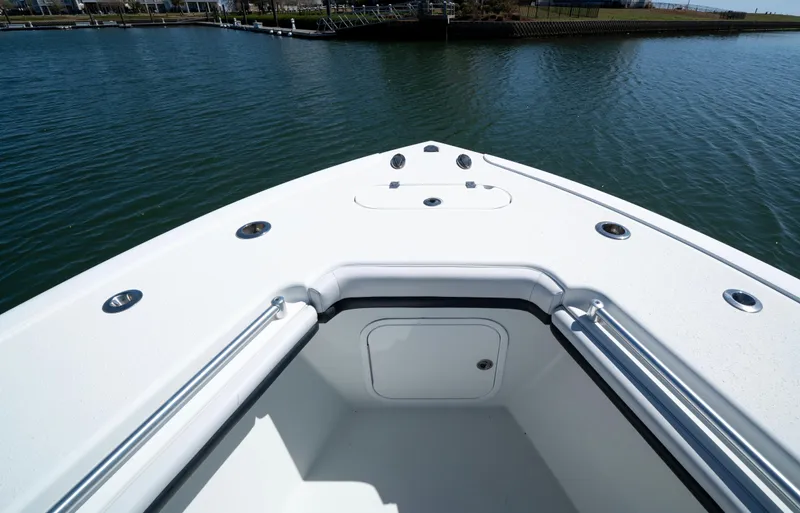  Yacht Photos Pics 2018 Yellowfin 32 Offshore boat bow on calm water, showcasing sleek design.