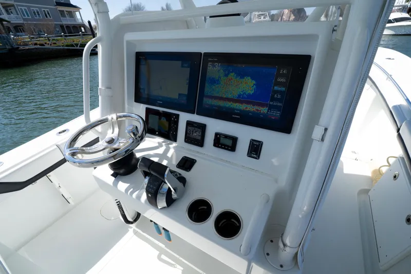 Yacht Photos Pics 2018 Yellowfin 32 Offshore boat dashboard with dual screens and steering wheel.