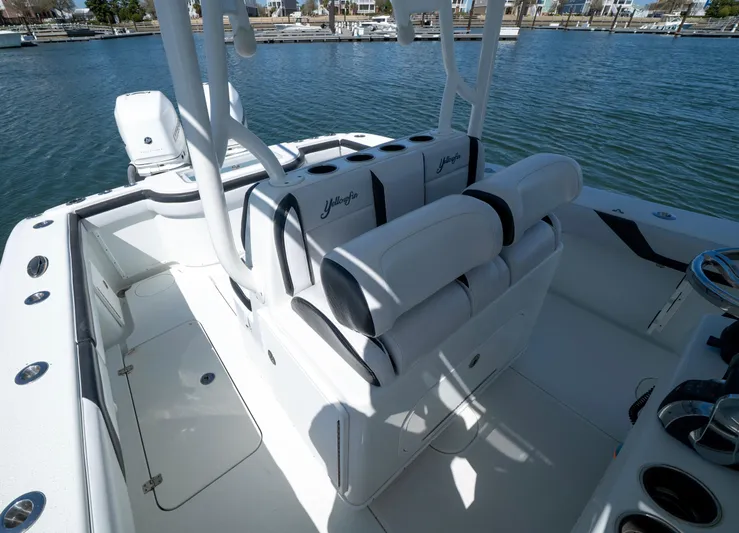  Yacht Photos Pics 2018 Yellowfin 32 Offshore boat interior with cushioned seating, docked by the water.