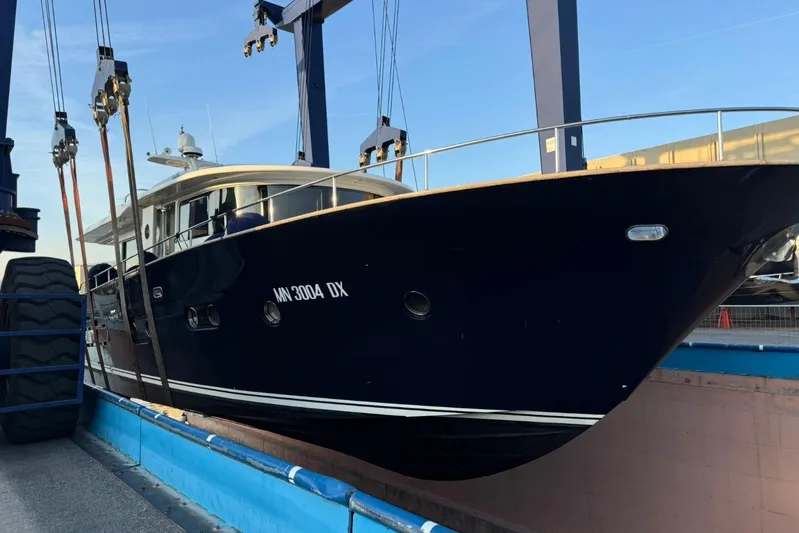  Yacht Photos Pics 2008 Apreamare Maestro 65 yacht in dry dock, side view with blue hull.