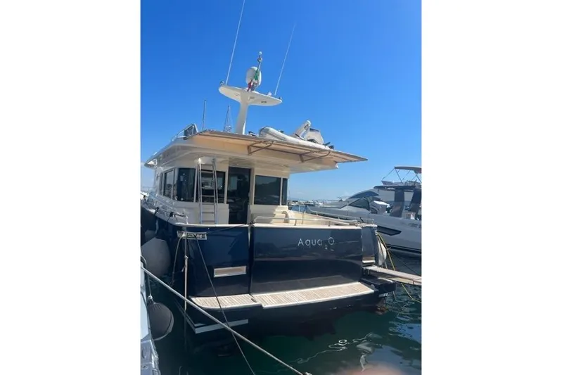  Yacht Photos Pics 2008 Apreamare Maestro 65 yacht docked in marina under clear blue sky.