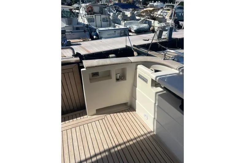  Yacht Photos Pics 2008 Apreamare Maestro 65 yacht deck with wooden flooring and marina view.