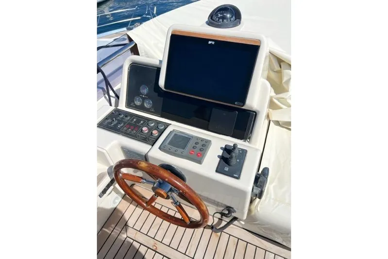  Yacht Photos Pics 2008 Apreamare Maestro 65 yacht helm with wooden steering wheel and navigation controls.