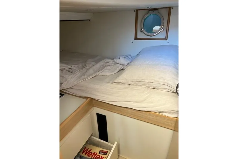  Yacht Photos Pics Cozy cabin interior of 2008 Apreamare Maestro 65 yacht with porthole and bedding.