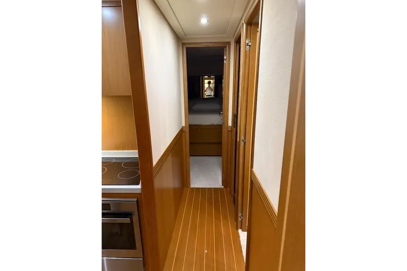  Yacht Photos Pics Narrow hallway inside 2008 Apreamare Maestro 65 yacht, featuring wood paneling and modern design.