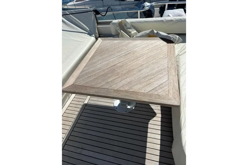  Yacht Photos Pics Wooden table on 2008 Apreamare Maestro 65 yacht deck, surrounded by seating.