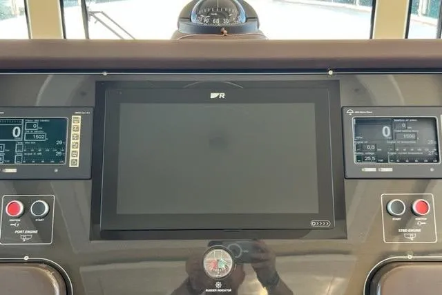  Yacht Photos Pics Control panel of a 2008 Apreamare Maestro 65 yacht with navigation screens and buttons.