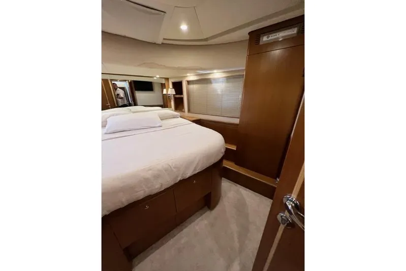  Yacht Photos Pics Luxurious cabin interior of 2008 Apreamare Maestro 65 yacht, featuring a cozy bed and wooden finishes.