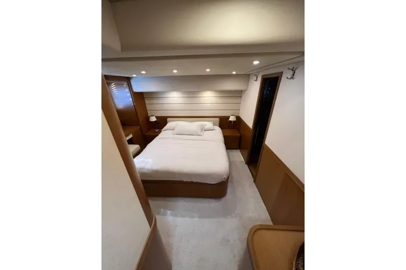  Yacht Photos Pics Luxurious bedroom interior of 2008 Apreamare Maestro 65 yacht, featuring elegant wood finishes.