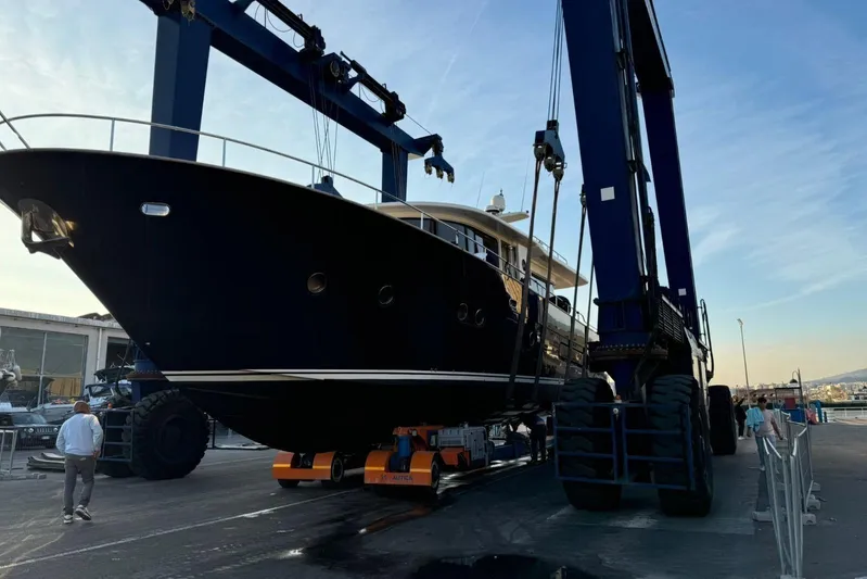  Yacht Photos Pics 2008 Apreamare Maestro 65 yacht being lifted by a large crane at a shipyard.