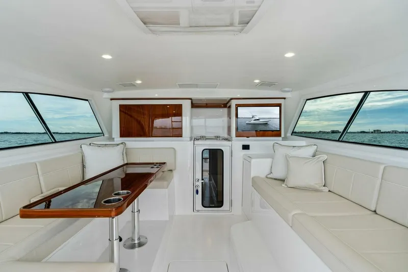 Damfino Yacht Photos Pics Luxurious interior of 2021 Viking 46 Billfish yacht with elegant seating and panoramic windows.