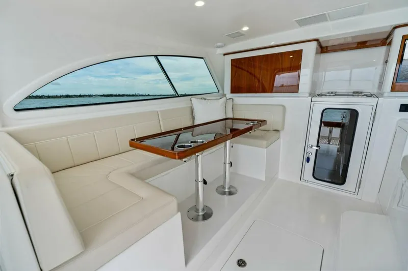 Damfino Yacht Photos Pics Luxurious interior of 2021 Viking 46 Billfish yacht with elegant seating and table.