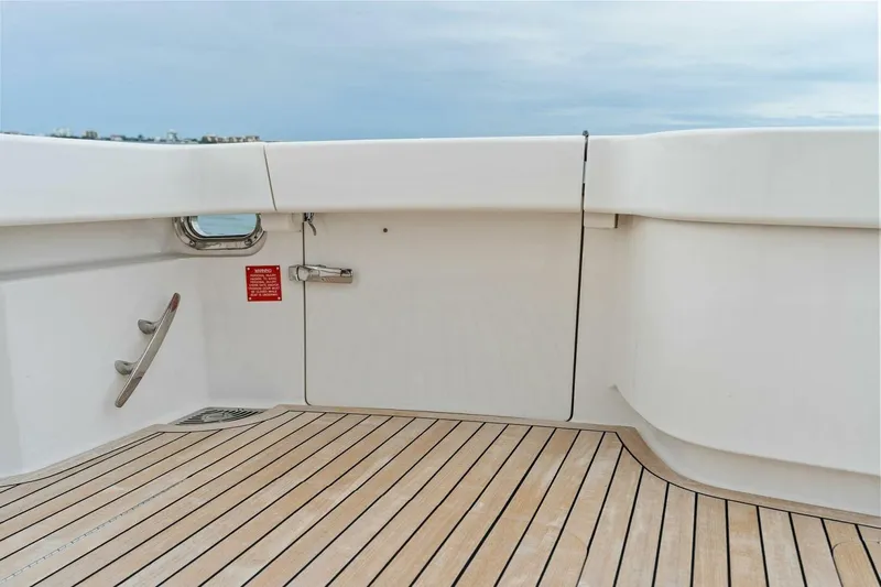 Damfino Yacht Photos Pics 2021 Viking 46 Billfish yacht deck with sleek white finish and wooden flooring.