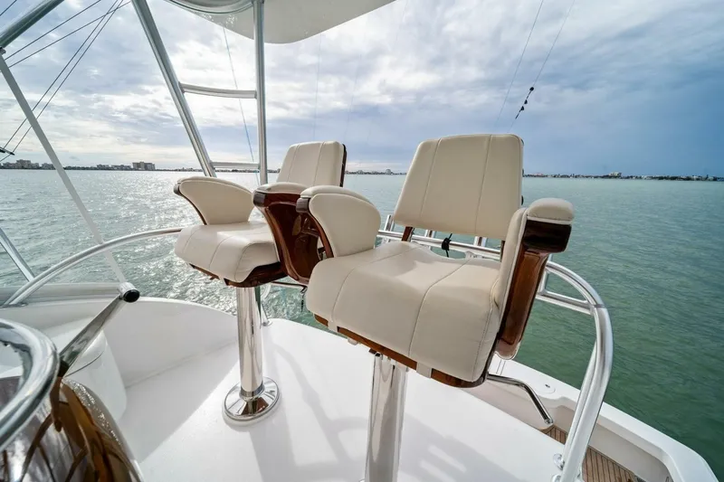 Damfino Yacht Photos Pics Luxury seating on 2021 Viking 46 Billfish yacht, overlooking serene waters.