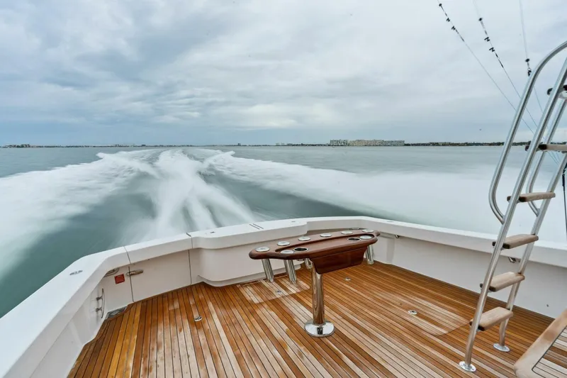 Damfino Yacht Photos Pics 2021 Viking 46 Billfish yacht cruising, showcasing teak deck and fishing setup.