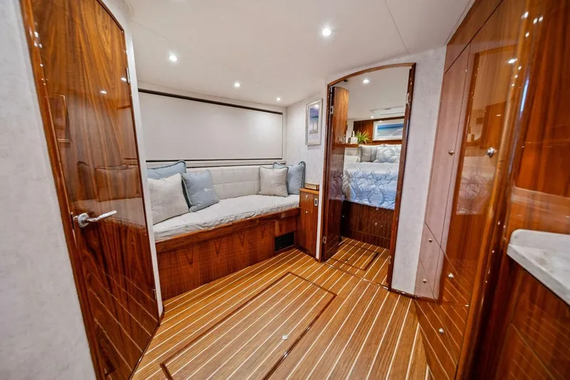 Damfino Yacht Photos Pics Luxurious interior of 2021 Viking 46 Billfish yacht with elegant wood finish and cozy seating.