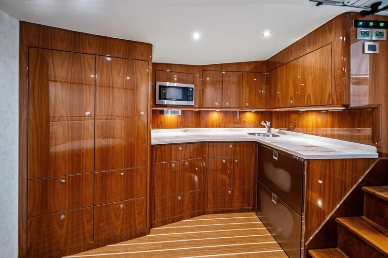 Damfino Yacht Photos Pics Luxurious wood-finished kitchen interior of 2021 Viking 46 Billfish yacht.