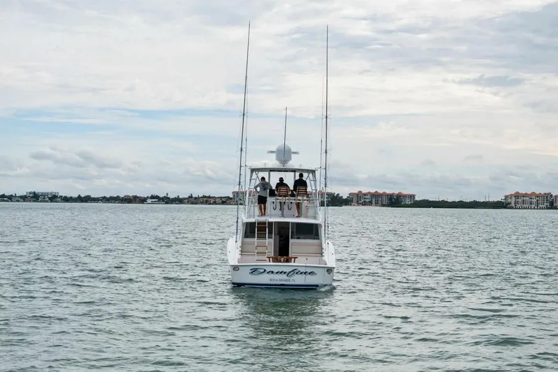 Damfino Yacht Photos Pics 2021 Viking 46 Billfish yacht cruising on calm waters under a cloudy sky.