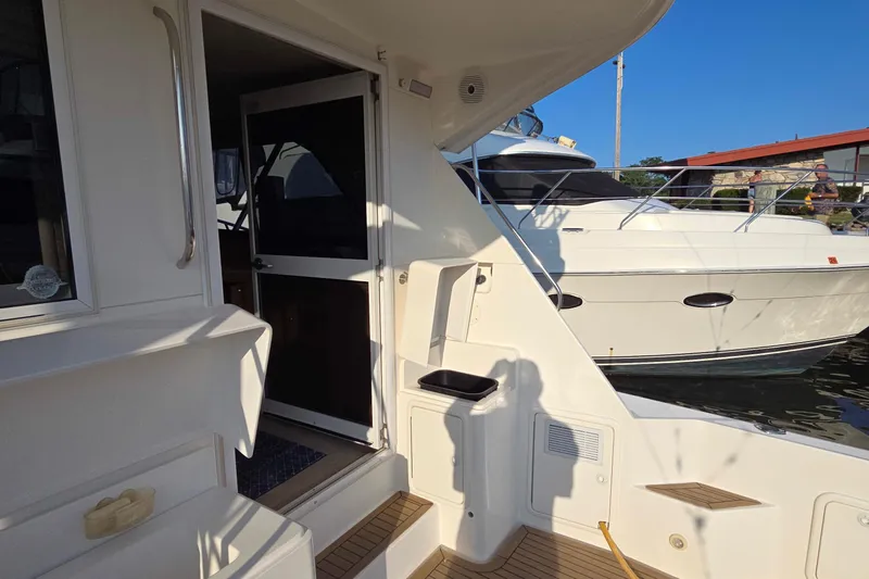 Buenos Aires Yacht Photos Pics 2003 Riviera 48 Flybridge yacht docked, showcasing entryway and deck details.