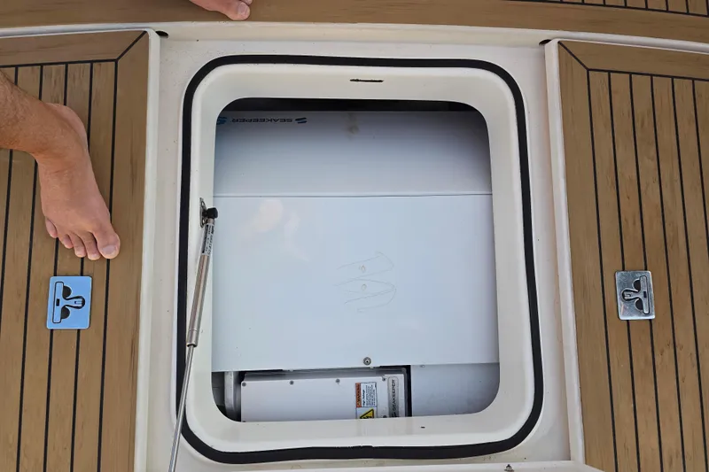 Buenos Aires Yacht Photos Pics Open hatch on 2003 Riviera 48 Flybridge boat deck, revealing storage compartment.