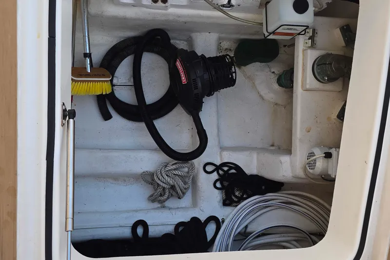 Buenos Aires Yacht Photos Pics Storage compartment on 2003 Riviera 48 Flybridge with cleaning tools and ropes.