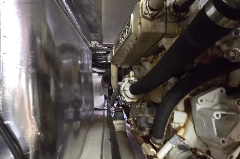 Buenos Aires Yacht Photos Pics Engine room of a 2003 Riviera 48 Flybridge yacht, showcasing mechanical components.