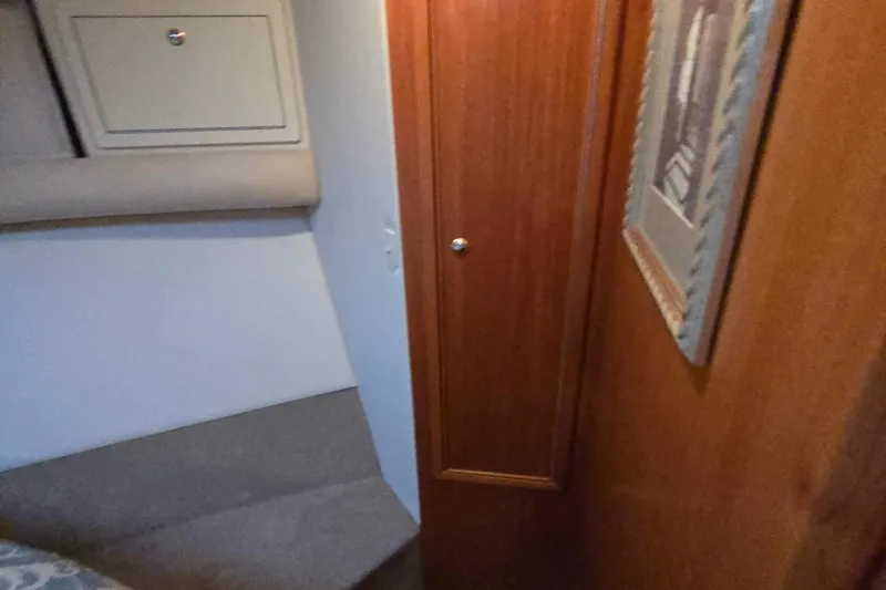 Buenos Aires Yacht Photos Pics Interior of 2003 Riviera 48 Flybridge yacht with wood paneling and storage.