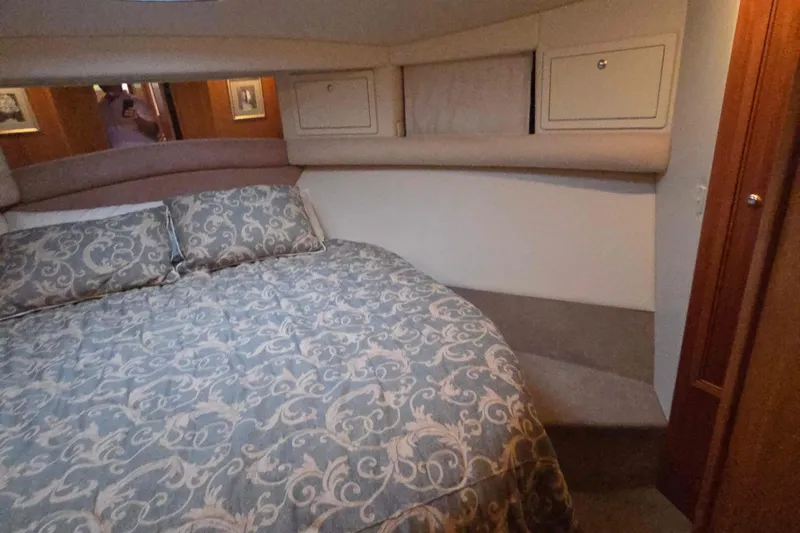 Buenos Aires Yacht Photos Pics Interior of 2003 Riviera 48 Flybridge yacht with elegant bedding and wood accents.