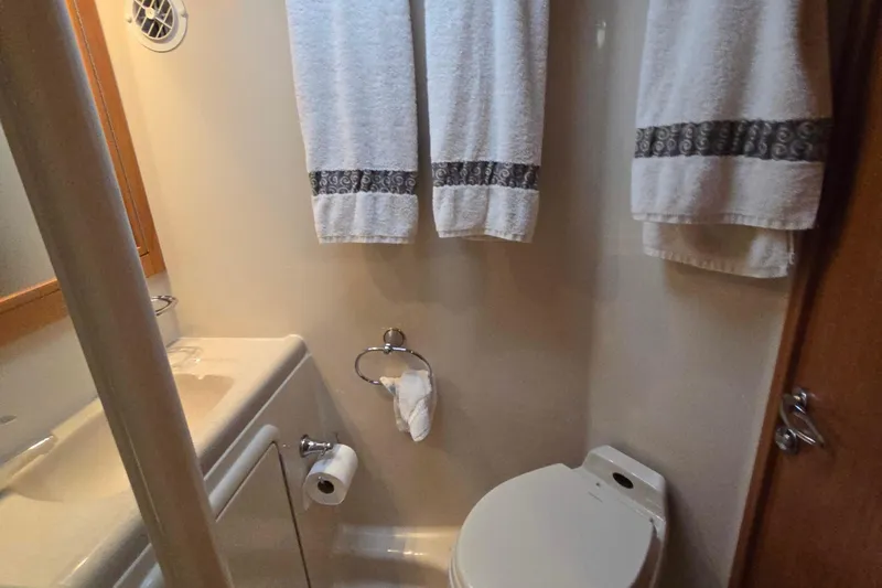 Buenos Aires Yacht Photos Pics Bathroom interior of 2003 Riviera 48 Flybridge yacht with towels and toilet.