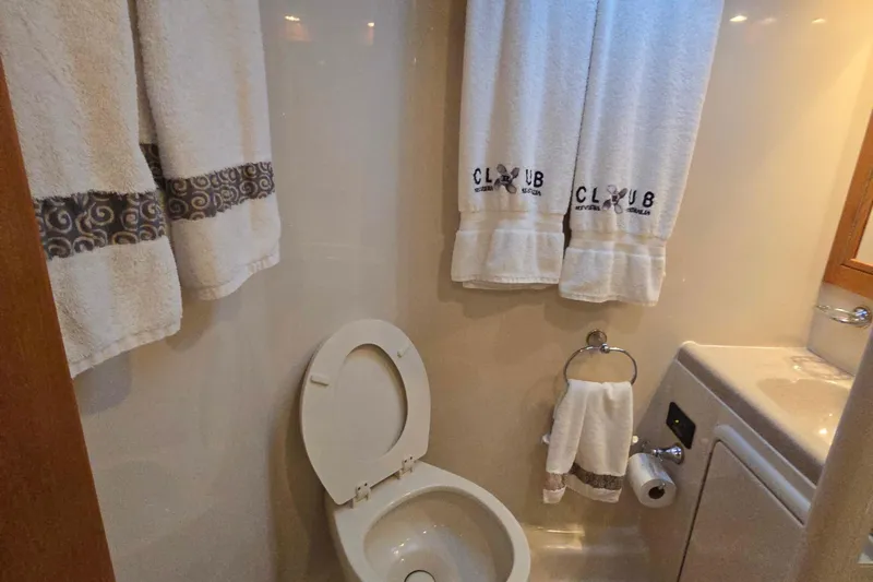 Buenos Aires Yacht Photos Pics Bathroom interior of 2003 Riviera 48 Flybridge yacht with towels and toilet.