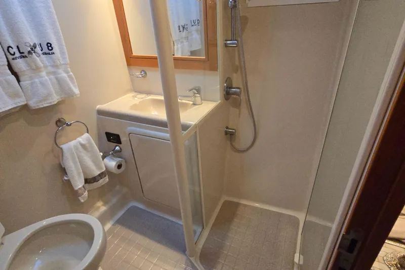 Buenos Aires Yacht Photos Pics Compact bathroom in 2003 Riviera 48 Flybridge yacht with shower and sink.