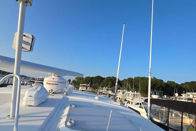 Buenos Aires Yacht Photos Pics 2003 Riviera 48 Flybridge yacht docked at marina under clear blue sky.