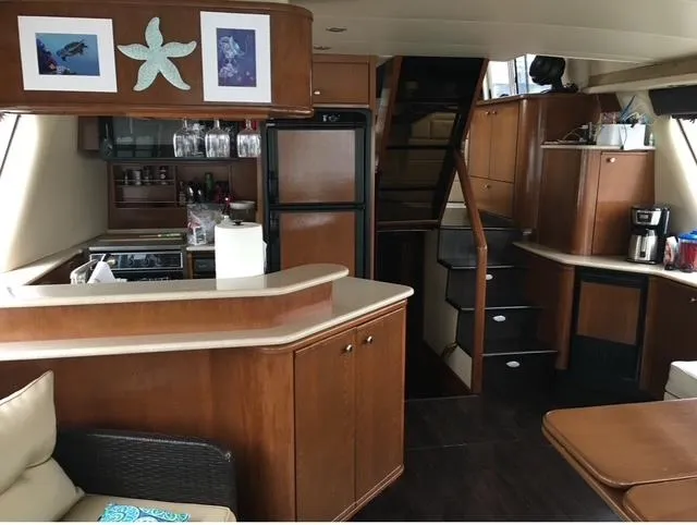  Yacht Photos Pics Luxurious 2005 Meridian PILOTHOUSE yacht interior with modern kitchen and elegant wood finishes.