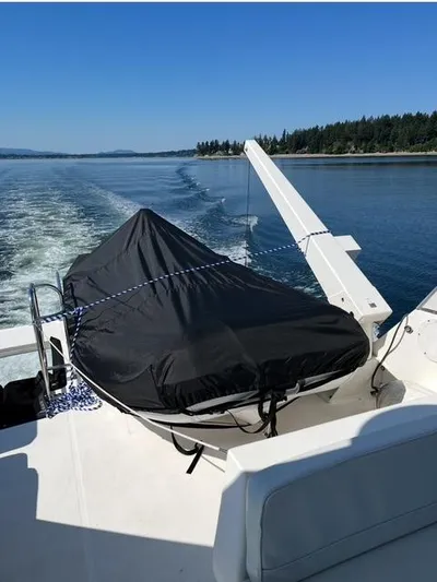  Yacht Photos Pics 2005 Meridian PILOTHOUSE boat with covered equipment, cruising on a scenic waterway.