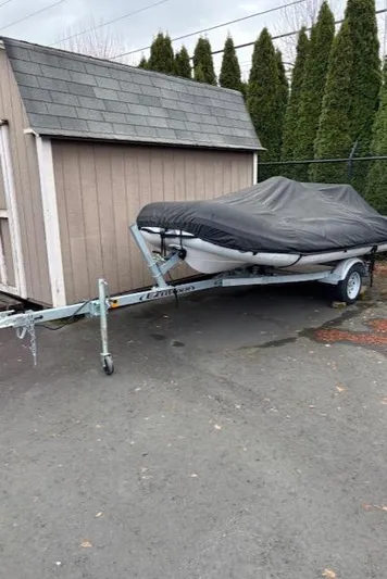  Yacht Photos Pics Covered 2005 Meridian PILOTHOUSE boat on trailer beside a shed.