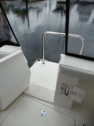  Yacht Photos Pics 2005 Meridian PILOTHOUSE boat deck with railing, overlooking calm marina waters.