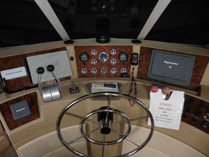  Yacht Photos Pics 2005 Meridian PILOTHOUSE helm with navigation controls and steering wheel.