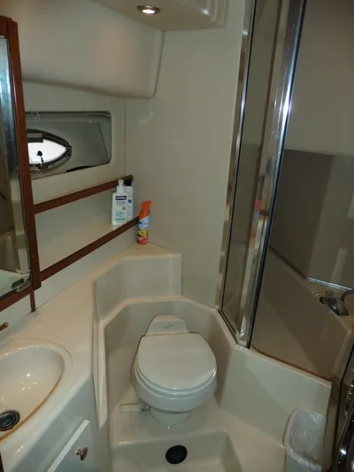  Yacht Photos Pics 2005 Meridian PILOTHOUSE bathroom with toilet, sink, and shower in compact layout.