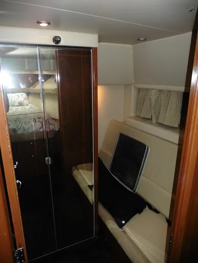  Yacht Photos Pics 2005 Meridian PILOTHOUSE interior with seating, glass doors, and cozy cabin space.
