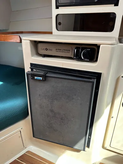  Yacht Photos Pics 2006 Albin 28 Tournament Express interior with compact fridge and gas stove.