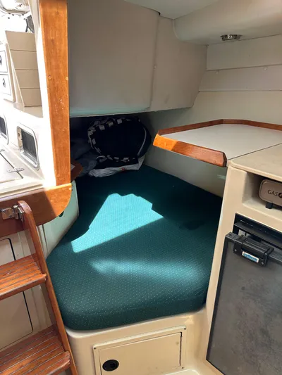  Yacht Photos Pics 2006 Albin 28 Tournament Express cabin interior with green cushioned seating and compact kitchenette.