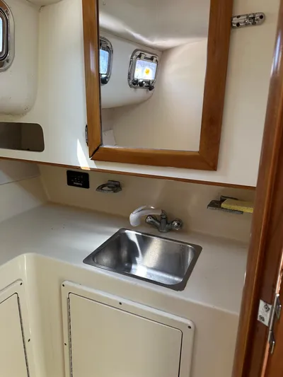  Yacht Photos Pics 2006 Albin 28 Tournament Express boat interior with sink and mirror.