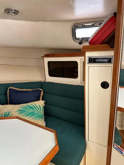  Yacht Photos Pics Interior of 2006 Albin 28 Tournament Express with green seating and wooden accents.