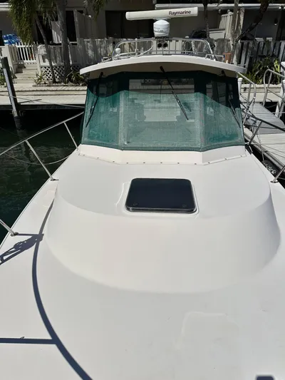  Yacht Photos Pics 2006 Albin 28 Tournament Express boat docked, featuring a sleek white exterior and green windshield.
