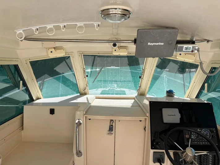  Yacht Photos Pics 2006 Albin 28 Tournament Express boat interior with steering wheel and navigation equipment.