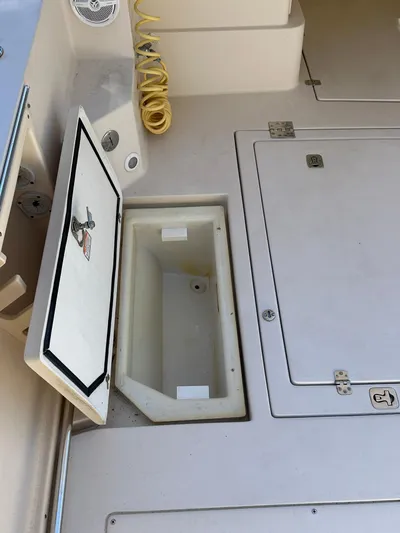  Yacht Photos Pics 2006 Albin 28 Tournament Express deck with storage compartments and hose.