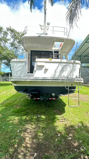  Yacht Photos Pics 2009 Beneteau Swift Trawler 34, rear view, on grass, under clear sky.
