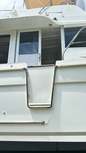  Yacht Photos Pics 2009 Beneteau Swift Trawler 34, rear view with door and railing details.