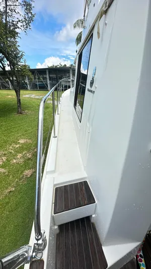  Yacht Photos Pics 2009 Beneteau Swift Trawler 34 side view with railing, docked on grass.