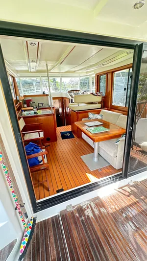  Yacht Photos Pics Interior of 2009 Beneteau Swift Trawler 34, featuring cozy seating and wooden flooring.